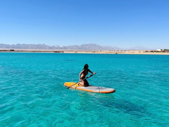 Boat floating on the Red Sea with clear blue water and horizon view in Hurghada, Egypt