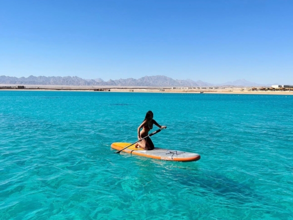 Boat floating on the Red Sea with clear blue water and horizon view in Hurghada, Egypt