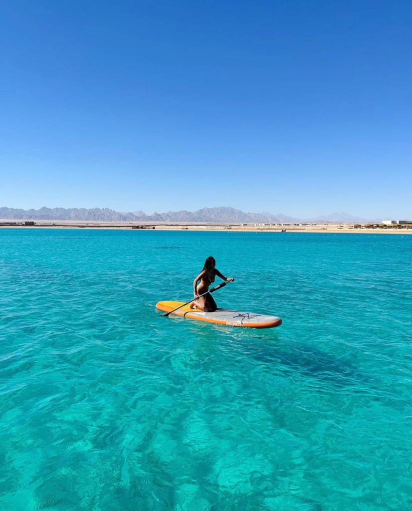 Boat floating on the Red Sea with clear blue water and horizon view in Hurghada, Egypt