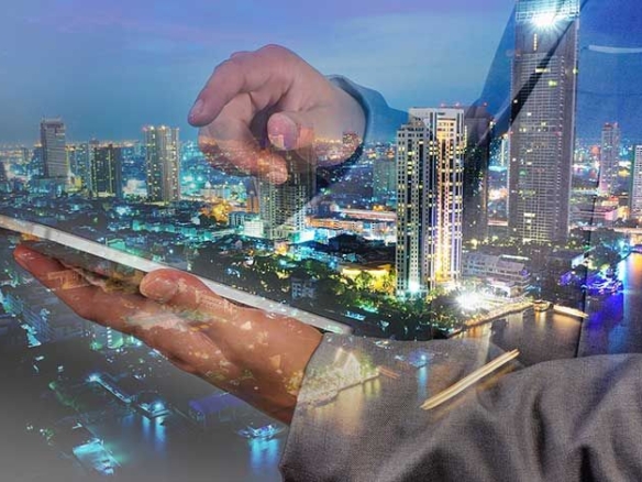 Future of Smart Cities in Real Estate showing modern urban skyline with smart infrastructure, IoT connectivity, and sustainable buildings