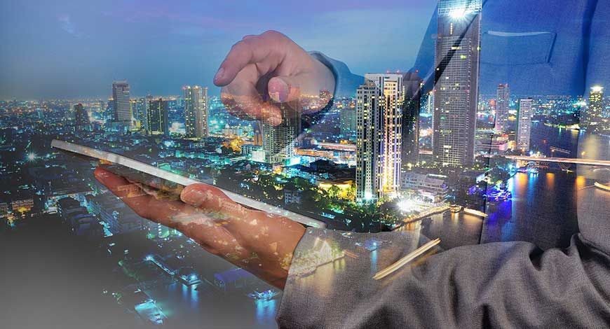 Future of Smart Cities in Real Estate showing modern urban skyline with smart infrastructure, IoT connectivity, and sustainable buildings